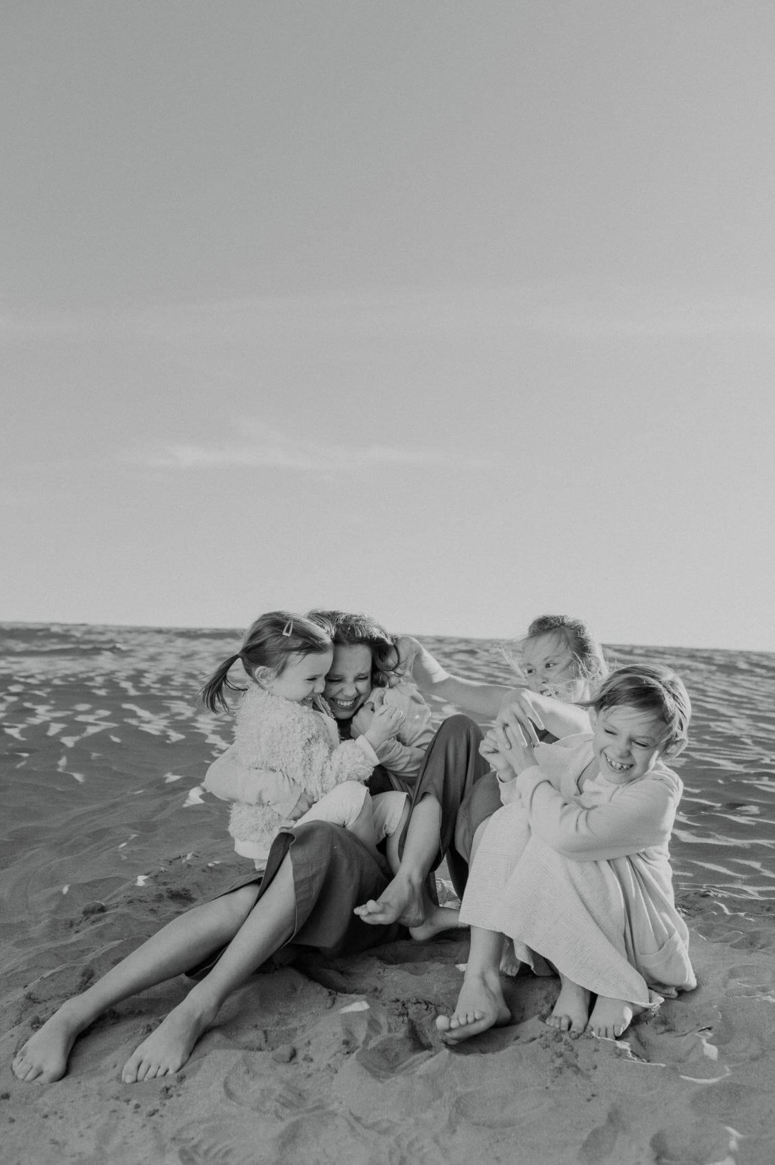 Children playing on a sand dune