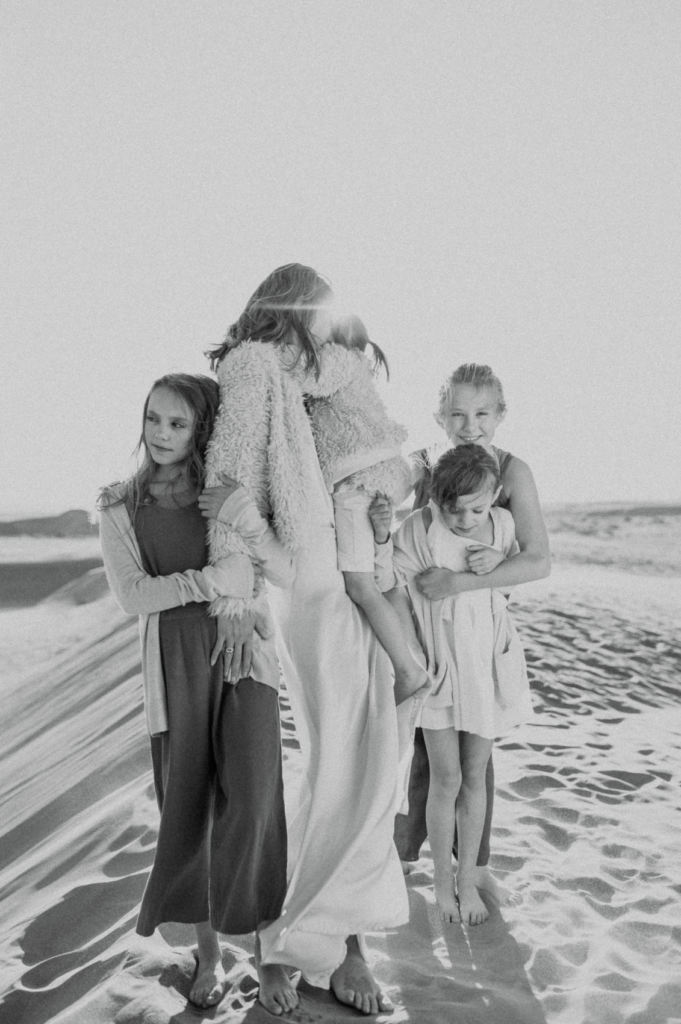 Mother and children on a sand dune