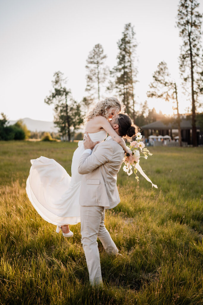 a couple dance in the grass at sunset at black butte ranch