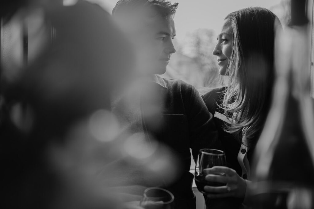 a couple sitting at a wine bar