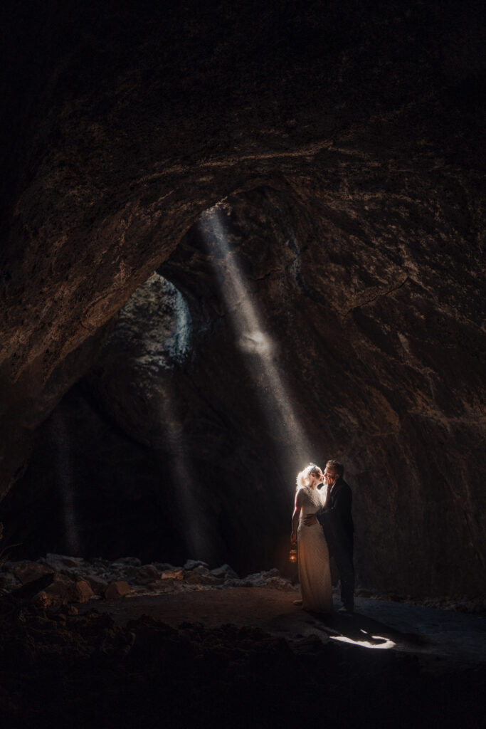 a couple in. cave on their wedding day