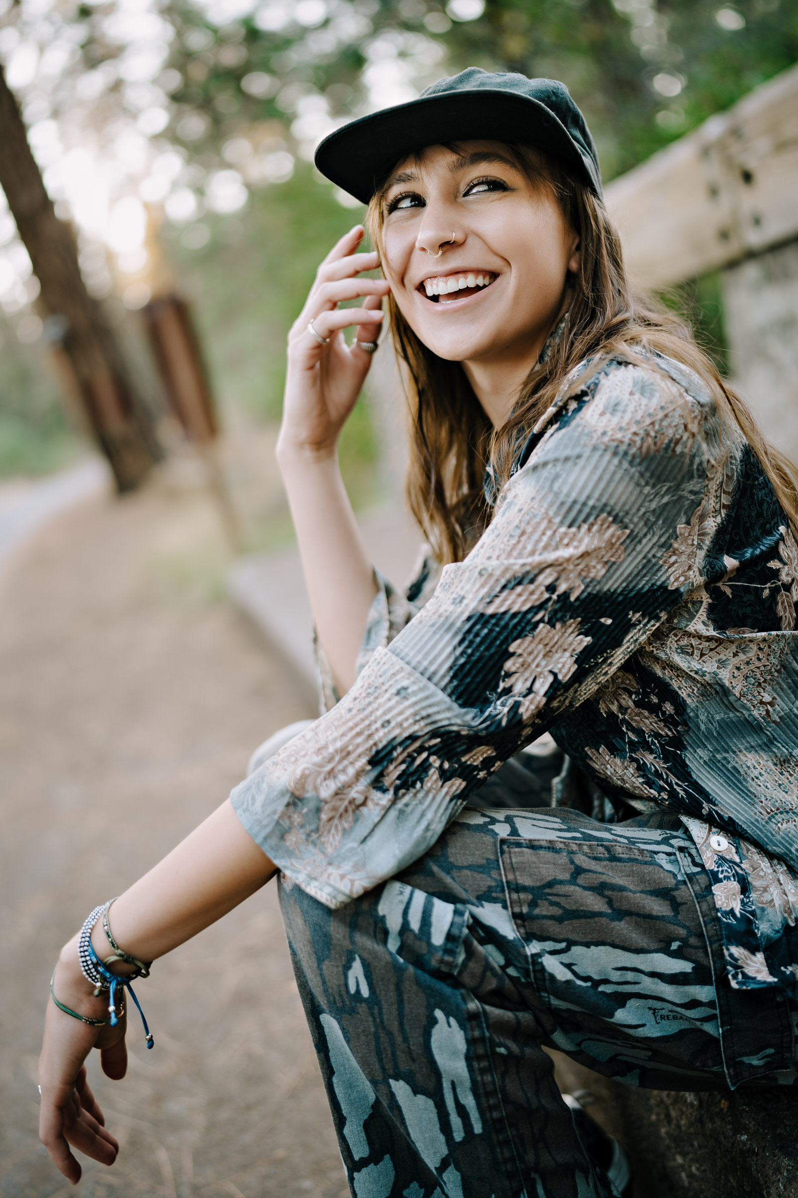 a young woman laughs during her senior portrait session